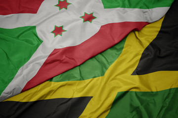 waving colorful flag of jamaica and national flag of burundi .