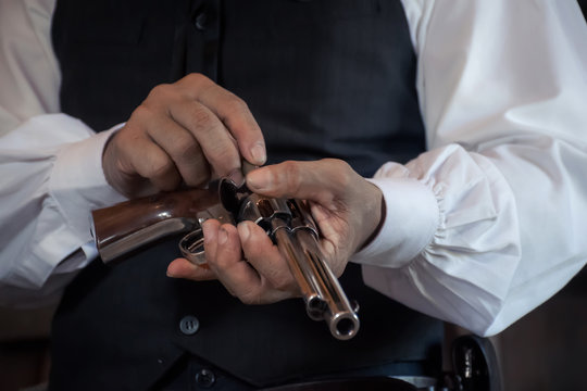 cowboy with gun prepares to gun fight.Conwboy with gun.