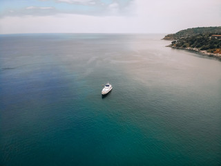Top view of the luxurious yacht in the vast blue sea; lifestyle concept.