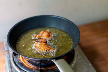 Fry the chicken in a pan with boiling oil.