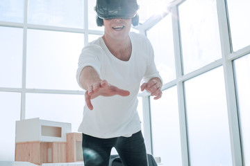Fototapeta na wymiar smiling young man in a virtual reality helmet