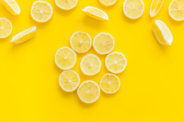 Lemon circle pattern on yellow background top view