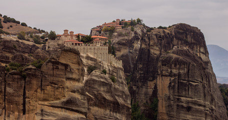 Christian highland monastery pilgrimage religion destination for believer people in Greece gorgeous rocky mountain wilderness scenic landscape environment in cloudy moody weather time 