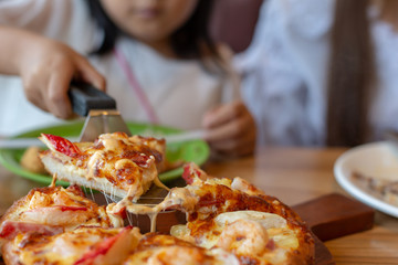 Seafood Italian Pizza slice on wood dish