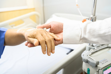 Doctor Holding hands Asian senior or elderly old lady woman patient with love, care, encourage and empathy at nursing hospital