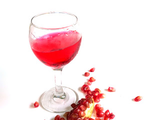 Pomegranate fruit and juice in the glass.