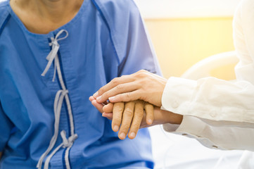 Doctor Holding hands Asian senior or elderly old lady woman patient with love, care, encourage and empathy at nursing hospital