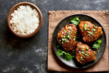 Grilled chicken thighs and bowl of rice