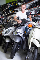 Fototapeta na wymiar Smiling male sitting on the motorbike
