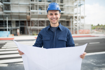 Site manager in front of a construction site