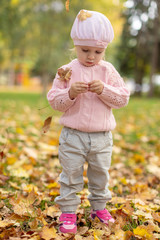 Little baby girl   in the autumn leaves 