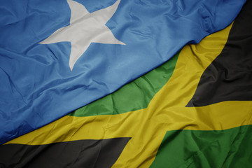 waving colorful flag of jamaica and national flag of somalia.