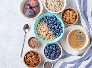 Healthy breakfast of superfoods, quinoa, honey, nuts, figs, coffee. Top view