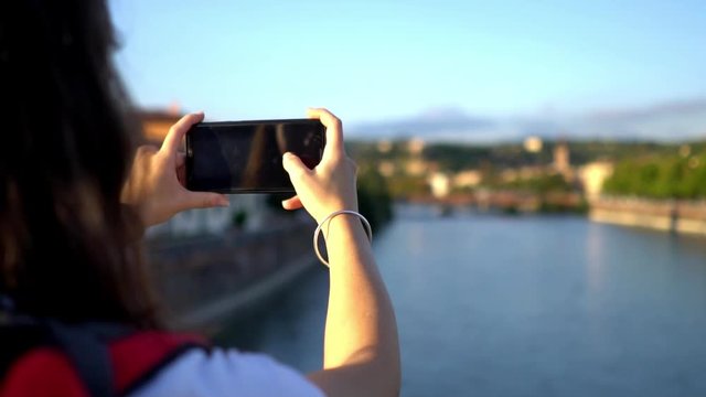 Female tourist taking picture with mobile phone