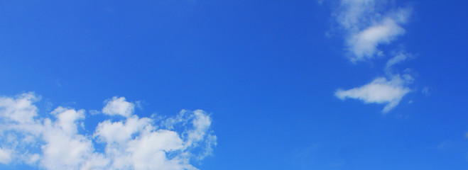 Blue cloudy sky texture. Empty bright blue sky with clouds background. Nature wallpaper of clear sky on sunny day
