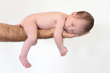Caucasian baby girl sleeping and smiling on one arm