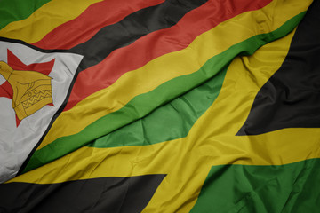 waving colorful flag of jamaica and national flag of zimbabwe.