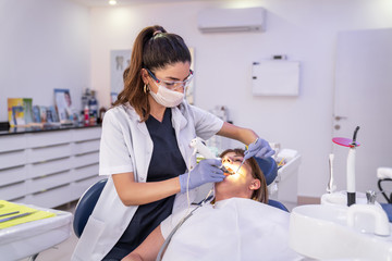Woman is getting dental treatment in a dentist clinic