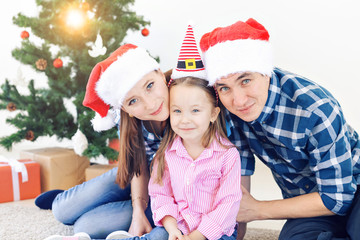 Holidays and festive concept - Happy family portrait by Christmas tree