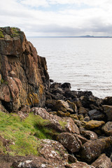 Fototapeta na wymiar Firth of Forth estuary in Aberdour, Fife. Scenic ocean view. Aberdour is a scenic and historic village on the south coast of Fife, Scotland.