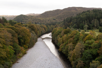Fototapeta na wymiar View of River Garry near Pitlochry in the area of Perth and Kinross in Scotland. Taken in autumn, october, overcast day.