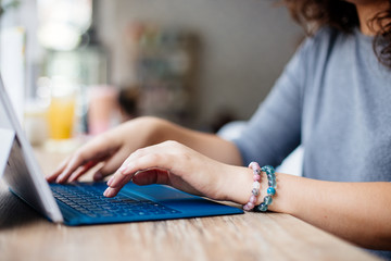 Girl with a laptop in a cafe.