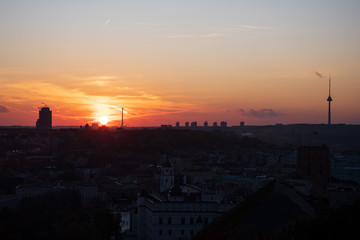 Naklejka premium Beautiful orange sunset over the city and Vilnius TV tower 