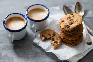coffee and cookies with chocolate chips on ceramic background