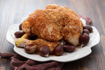 raw chicken with chestnut on white dish