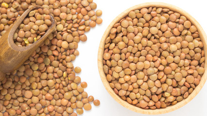 Brown lentils. Wooden scoop