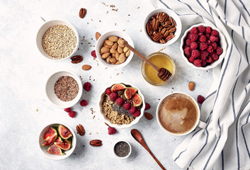 Healthy breakfast, oatmeal with raspberries, figs and nuts and seeds. The concept of a healthy lifestyle, diet. Top view