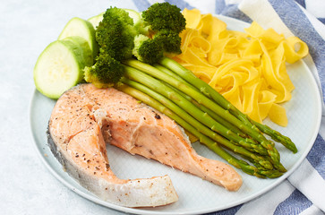 Healthy food, steamed salmon, with steamed vegetables. Eggplant, broccoli, asparagus.