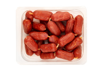 Small smoked sausages on a white background. Grilled sausages close-up in a plastic container. Top view.