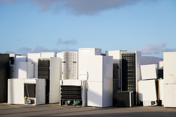 Old fridges freezers refrigerant gas at refuse dump skip recycle stacked pile plant help...