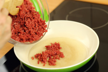Adding ground beef into frying pan