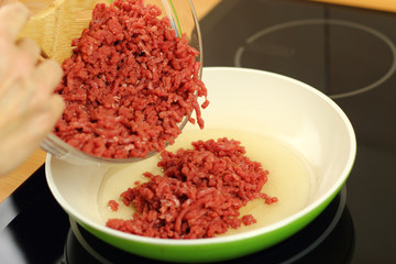 Adding ground beef into frying pan