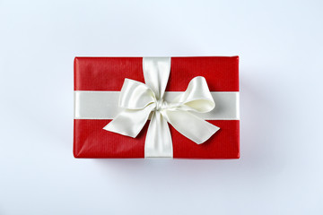 Bunch of christmas presents wrapped in red and white paper tied with shiny silk bow. Multiple new years gifts in red and white wrapping. Top view, close up, copy space, background, flat lay.