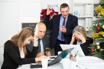 Unhappy businessman scolding his subordinates