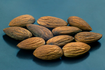 walnut almonds handful close-up on a dark plate