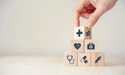 Poster Health Insurance Concept, Hand arranging wood cube stacking with icon healthcare medical on wood background, copy space, financial concept. © oatawa