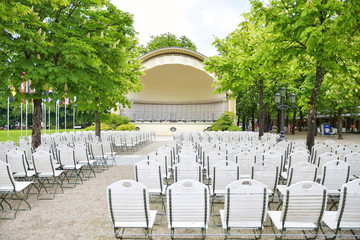 Baden-Baden, Germany - May, 2019. Summer theater with stage and rows of white chairs. Beautiful view of the historic town Baden-Baden. Famous thermal water spa resort  Baden-Baden, Germany. 