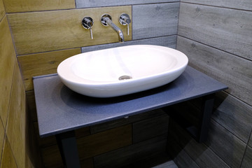 Classic modern white washbasins with chrome water tap and soap dish.