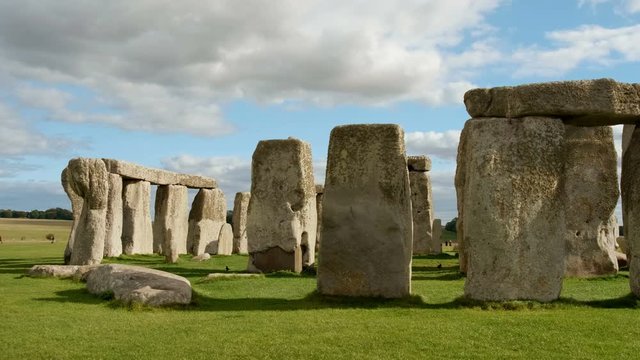 Tracking view of Stonehenge and Wiltshire Countryside in England, UK. The stone circle dates to 3000 BC and is one of the best known ancient wonders of the world and UNESCO World Heritage Site.