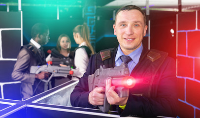 Businessman playing laser tag