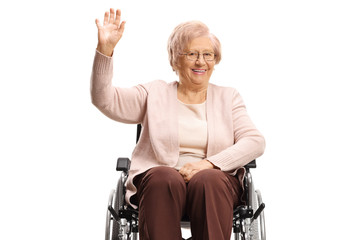 Disabled senior woman sitting in a wheelchair and waving