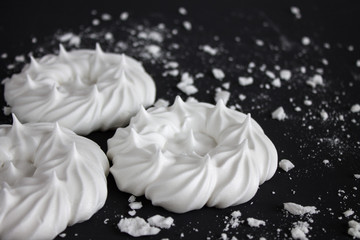 White meringue with crumbs on a black background