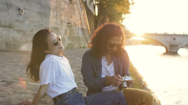 Couple taking photos at sunset in Paris France