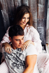 Fototapeta na wymiar girl and guy in pajamas sitting on windowsill and looking out th