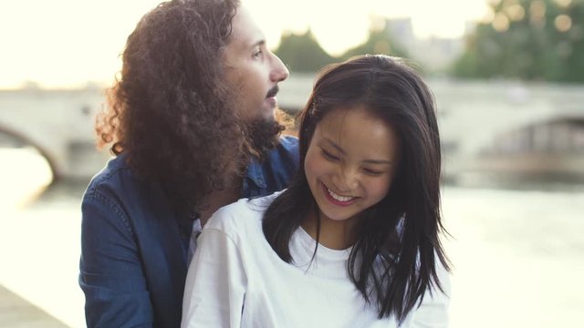 Couple kissing at sunset in Paris France