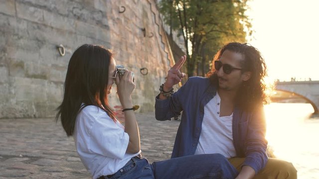 Couple taking photos at sunset in Paris France